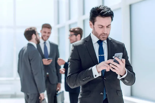 Empresario escribiendo SMS en el teléfono inteligente — Foto de Stock