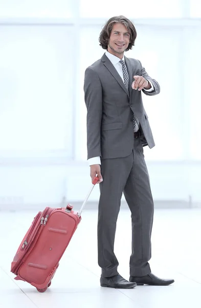 Businessman with a suitcase a road ,pointing ahead — Stock Photo, Image