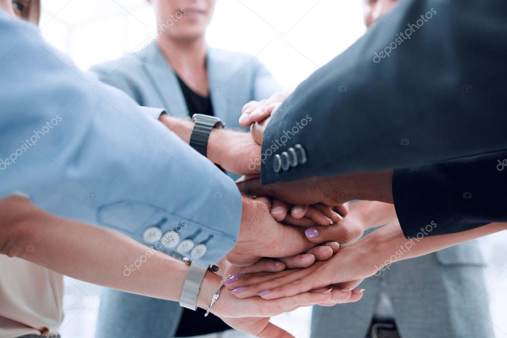 Business people joining hands in circle