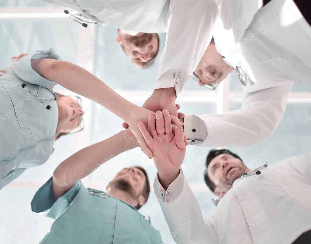 Health care workers demonstrating unity, bottom view