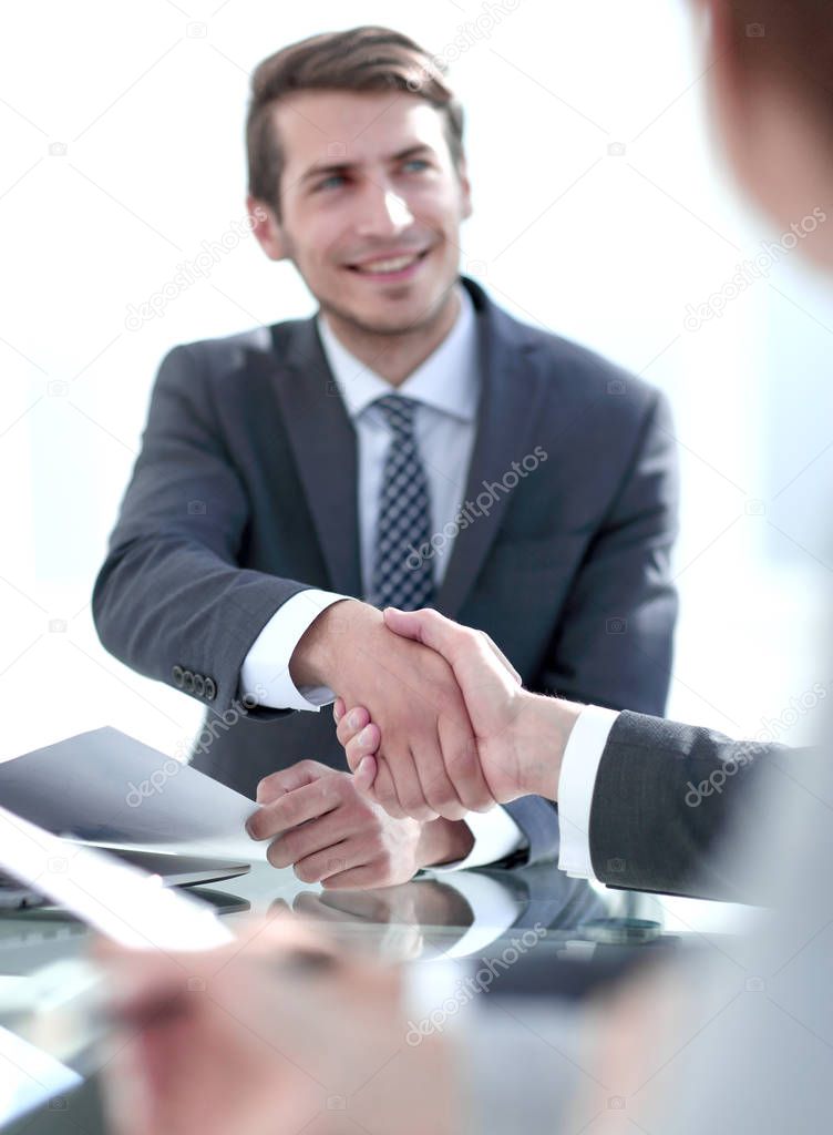 business handshake over the Desk.