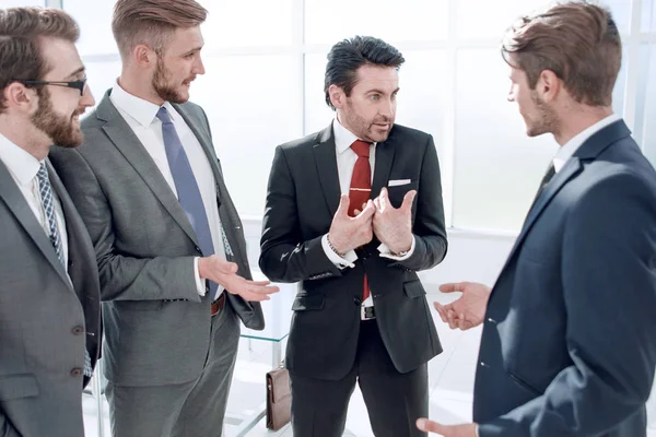Equipe de negócios se comunica em pé no escritório — Fotografia de Stock