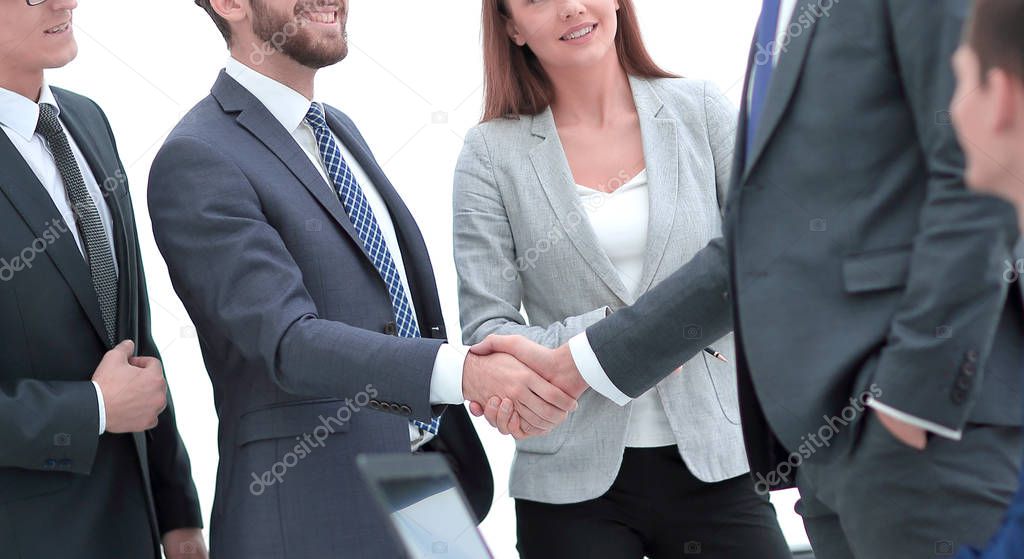 handshake business partners in the office