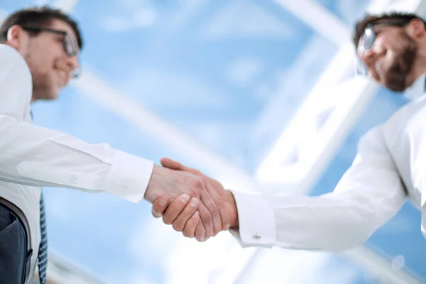 Bottom view.background image of a handshake of business people — Stock Photo, Image