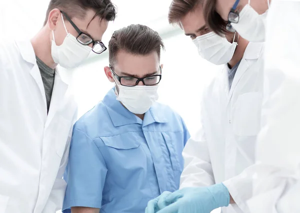 Closeup. a team of doctors in protective masks. — Stock Photo, Image