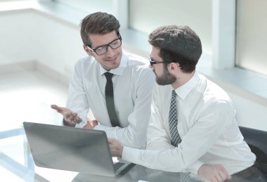 dizüstü bilgisayar ekranına bakarak iki iş arkadaşları