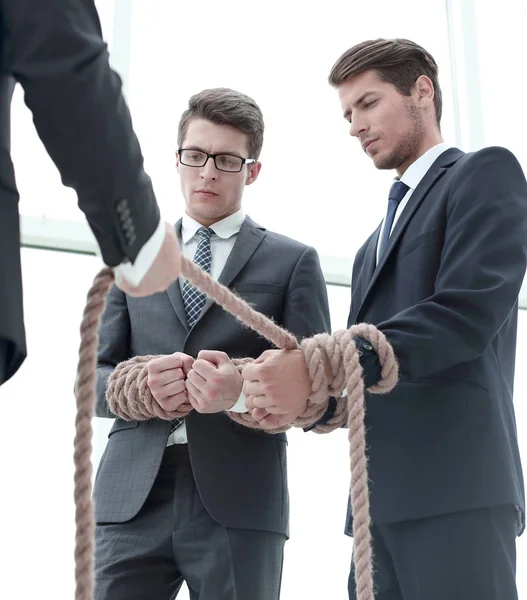 Close up.business leader pulls related employees — Stock Photo, Image