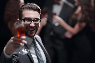 elegant man raising a glass of champagne
