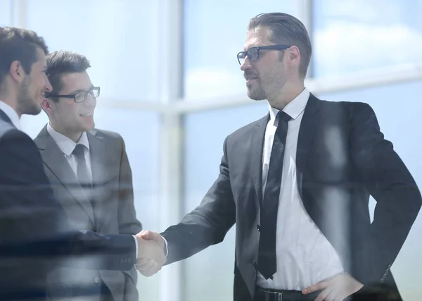 Handshake business partners in a modern office — Stock Photo, Image