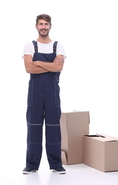 Man courier standing near cardboard boxes — Stock Photo, Image