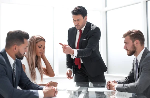 strict boss at a meeting with the business team.