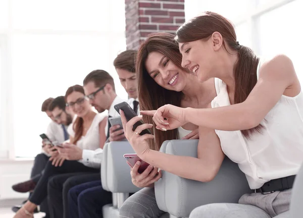Young employees of the company using their gadgets — Stock Photo, Image