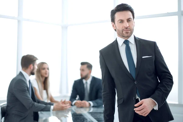 Serious businessman standing in a modern office. — Stock Photo, Image