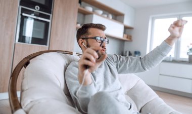 mutlu adam bir sandalyede otururken selfie çekerken