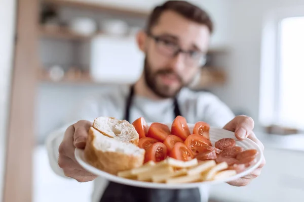 Тарілка бутербродів в руках привабливої людини — стокове фото