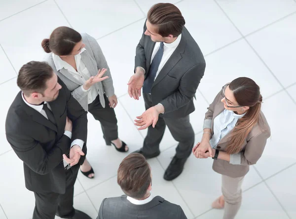 Top view.un grupo de empleados hablando de pie en la oficina — Foto de Stock