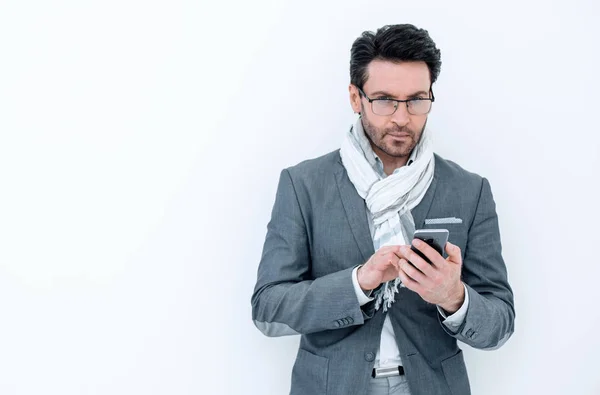 businessman with scarf on neck typing SMS on smartphone.