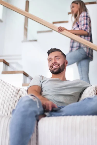 Close up. young man sitting on sofa. — Stock Photo, Image