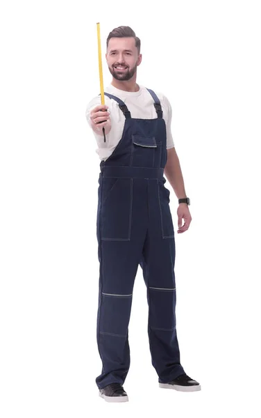 Man i overaller med en konstruktion måttband. isolerad på vitt — Stockfoto