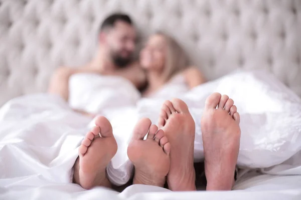 Background image of a couple in love lying on the bed — Stock Photo, Image