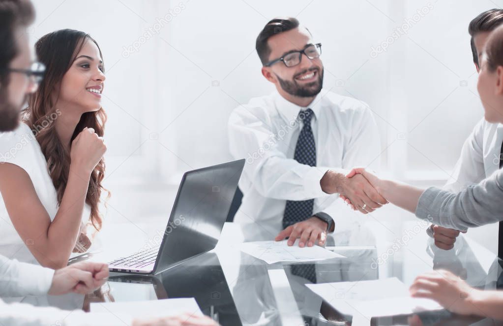 handshake business partners at the conclusion of the transaction