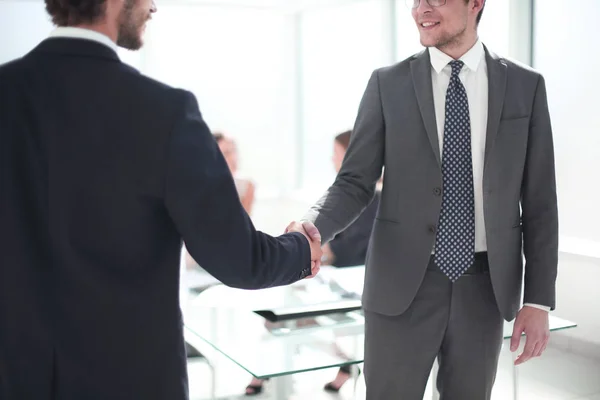 reliable handshake of business partners in the office
