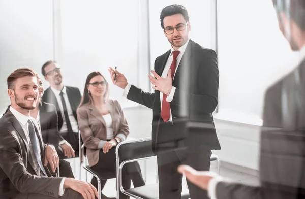 through the glass.the Manager makes a report at a business meeting