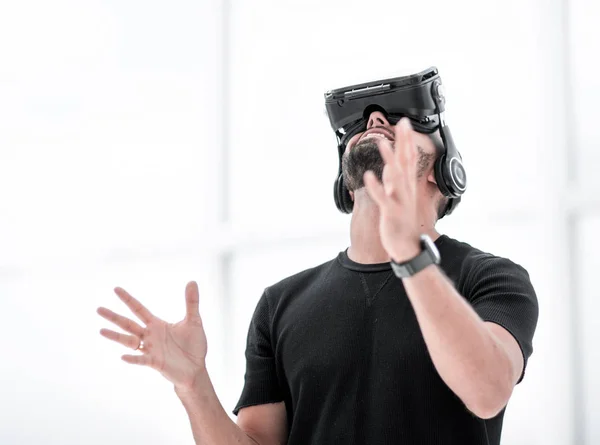 Retrato de um cara surpreso usando um fone de ouvido realidade virtual isolado — Fotografia de Stock