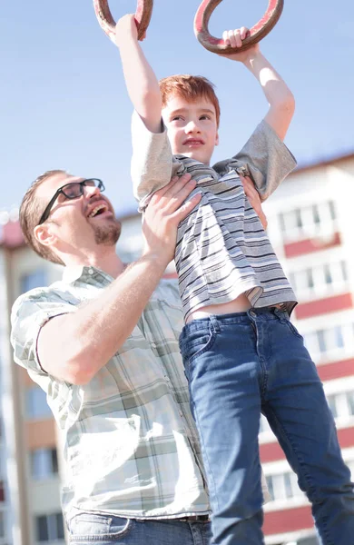 Far hjälper till sin son att komma ikapp på baren — Stockfoto