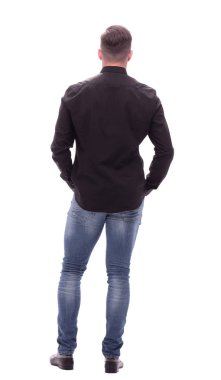 arka görünüm. kot genç adam ileriye bakıyor