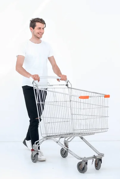 Lächelnder Mann schiebt Einkaufswagen. — Stockfoto