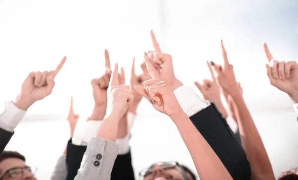 group of young entrepreneurs pointing up to a copy of the space