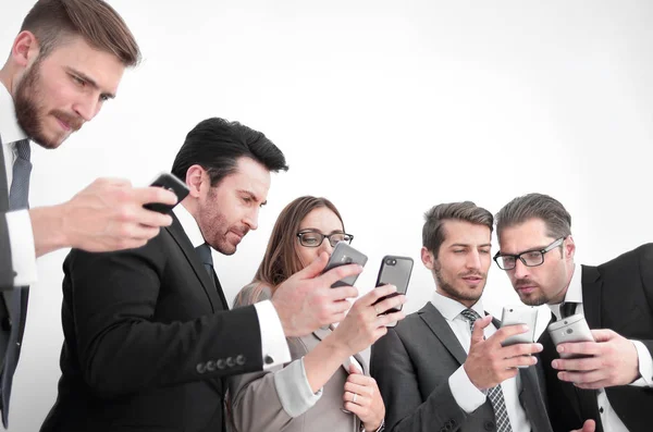 Business team looking at the screens of their smartphones — Stock Photo, Image