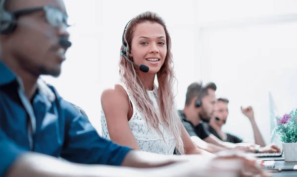 Smiling call center employee sitting at his Desk — Stock Photo, Image