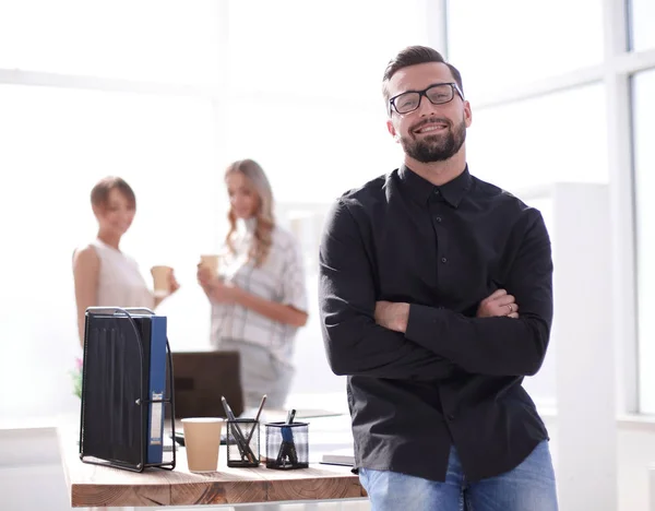 positive business man sitting near the desktop