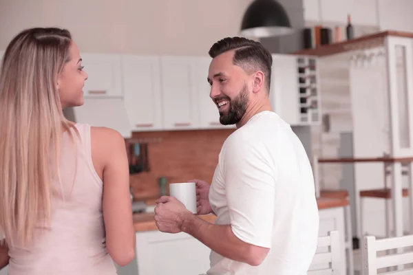 dreams of a young couple standing in their kitchen