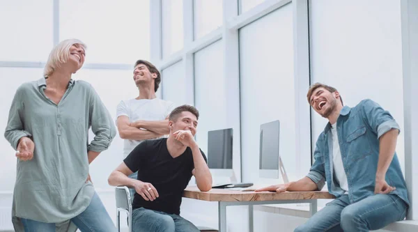 Cheerful team of young people in the workplace. — Stock Photo, Image