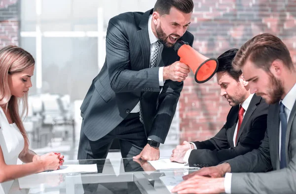 Businessman yelling through a megaphone during a meeting — Stock Photo, Image