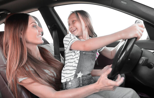 mom and her daughter driving a car
