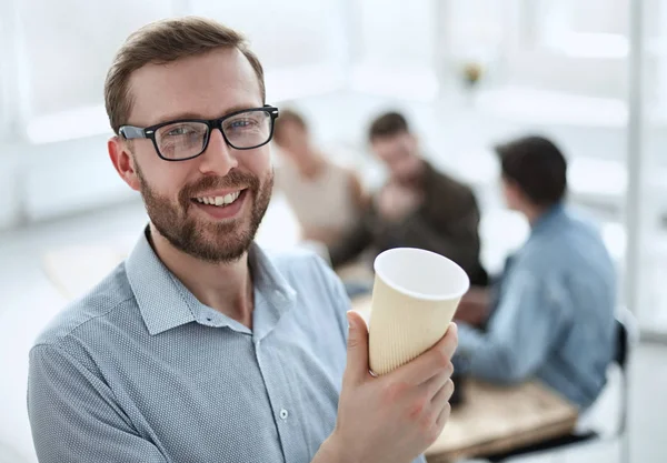 business man with a Cup of coffee standing in the office
