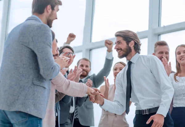 corporate group of employees congratulating each other on the victory