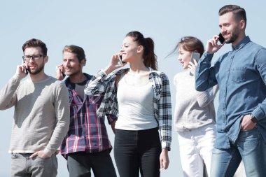 onların akıllı telefonlar üzerinde konuşurken öğrenci grubu.
