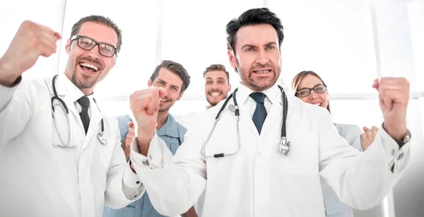 A victory sign of a team of doctors in white coats — Stock Photo, Image