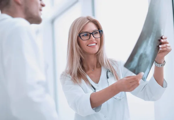 close up. happy doctors looking at patients x-ray .