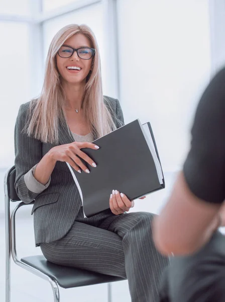 Young business woman asking questions during interview.