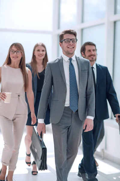 Gente de negocios caminando con confianza en un moderno edificio de oficinas — Foto de Stock