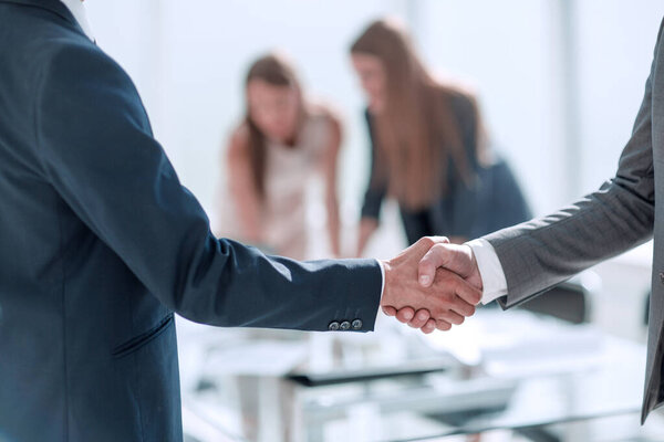 handshake of business people in the background of the office