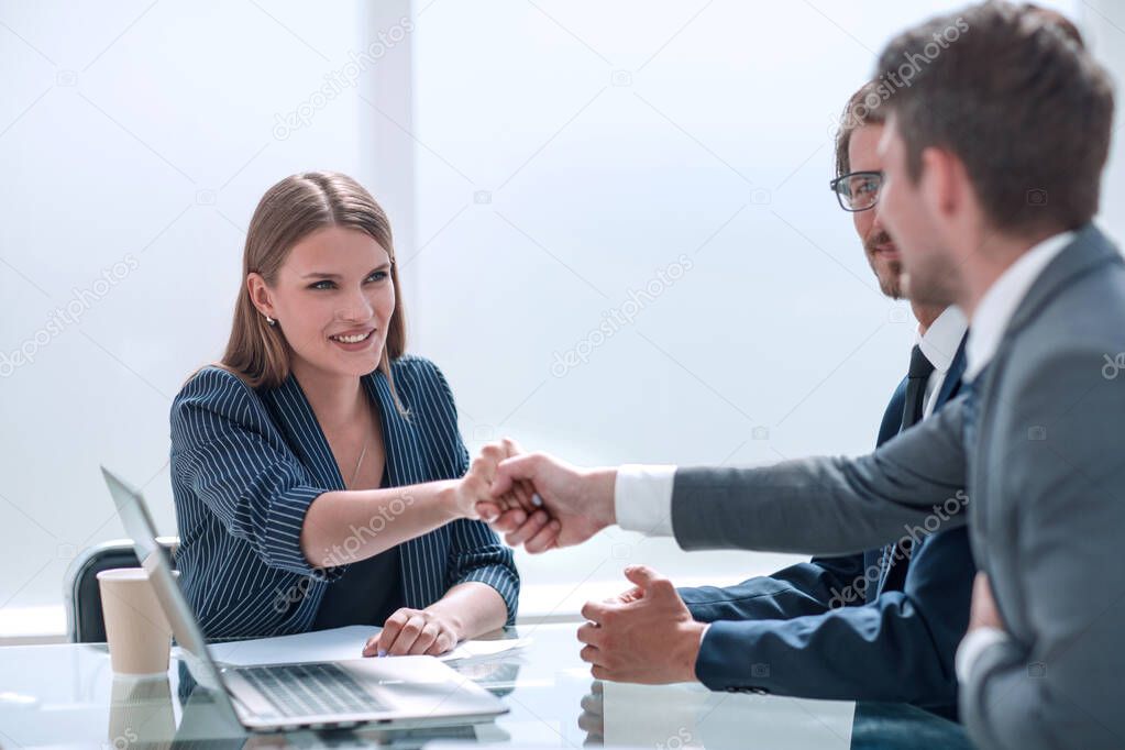 Business people shaking hands over the Desk