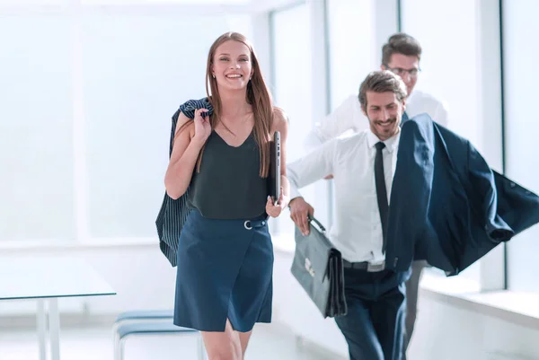 cheerful employees completing their work day at the office