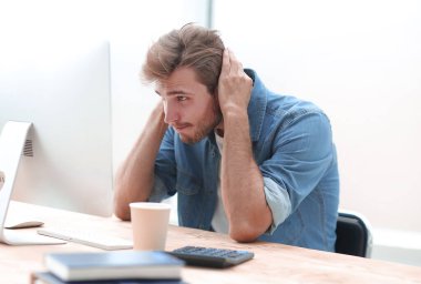 genç işadamı, bilgisayarının ekranına dikkatle bakıyor